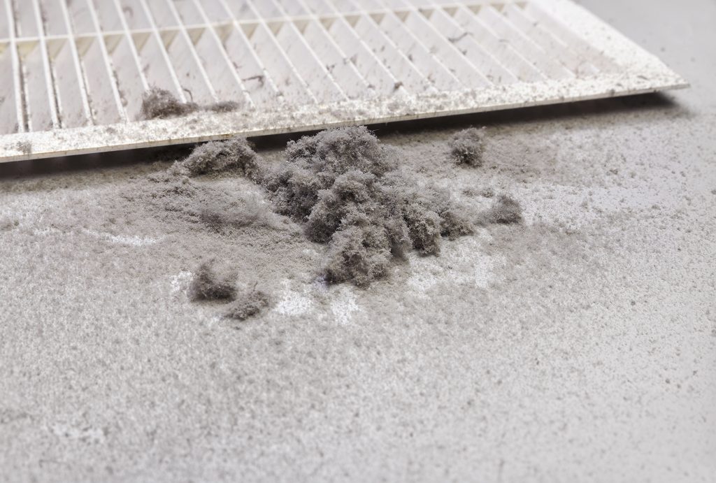 Dust on the floor next to air vent